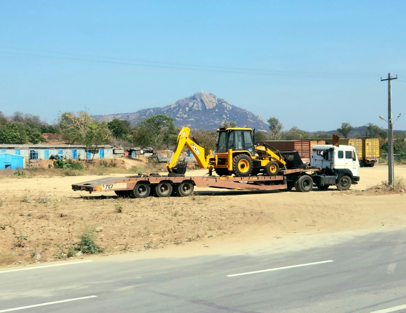 Backhoe loader on trailer